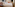 Modern hotel room with bed, diverse artworks, orange chair, and wall TV.