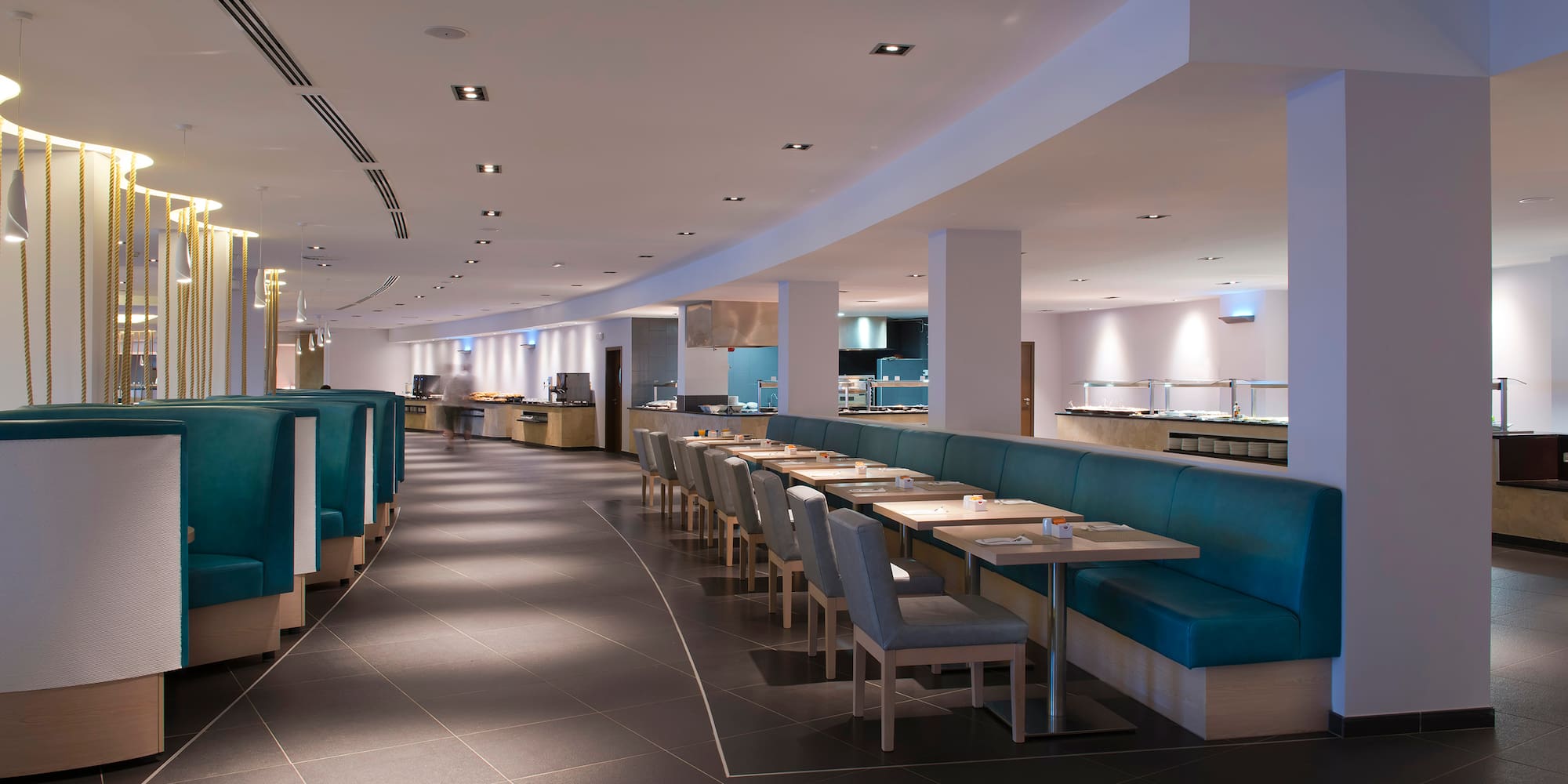 a restaurant with blue booth seating and blue chairs