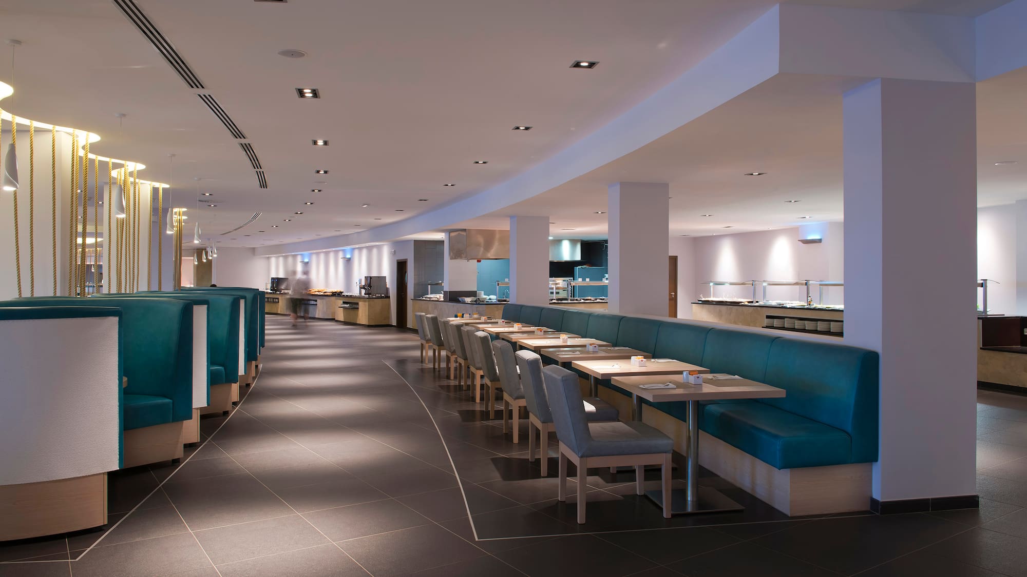 a restaurant with blue booth seating and blue chairs