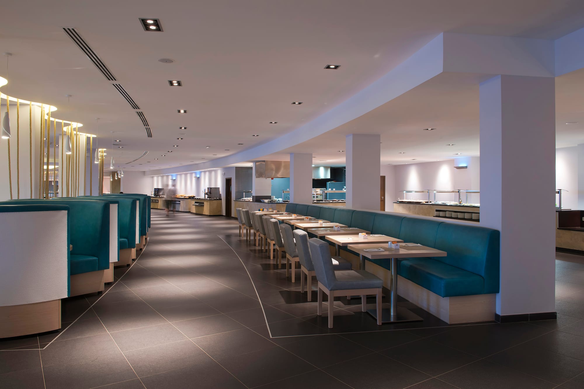 a restaurant with blue booth seating and blue chairs