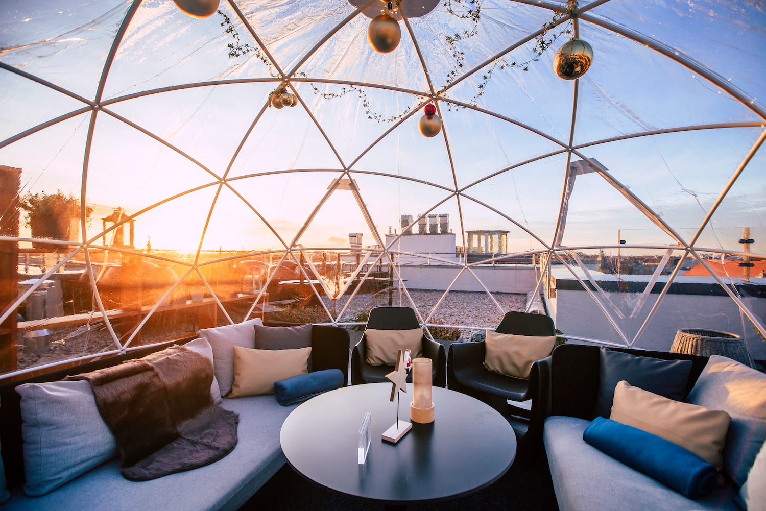 a round table with pillows inside a dome