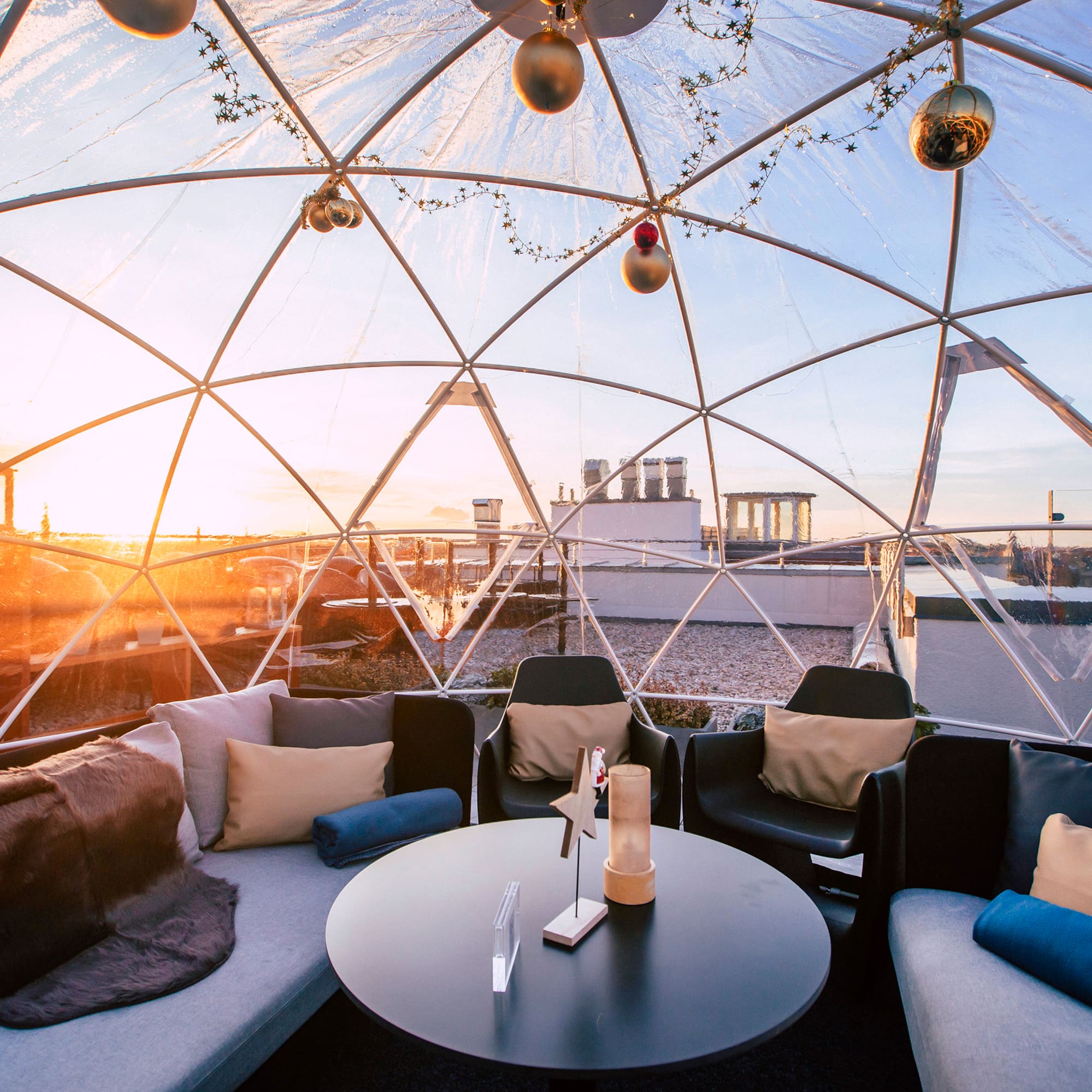 a round table with pillows inside a dome