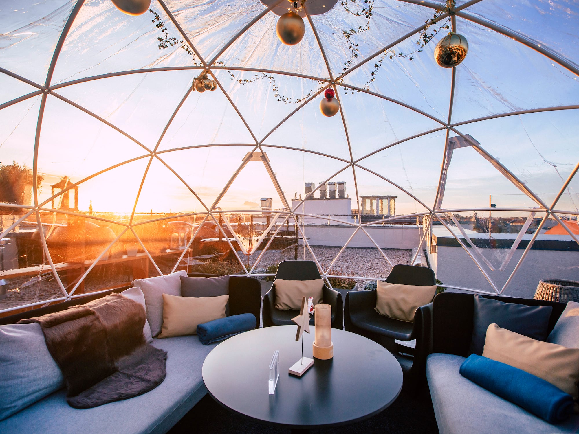 a round table with pillows inside a dome