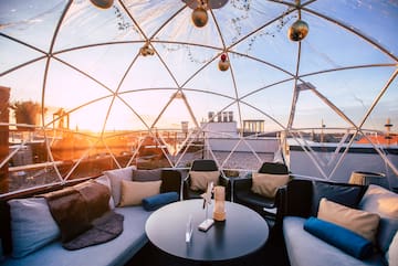a round table with pillows inside a dome