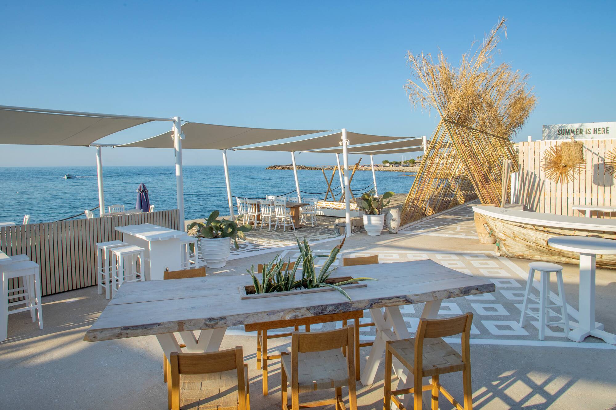 a table and chairs on a beach