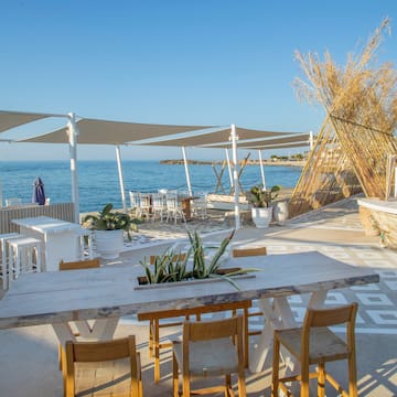 a table and chairs on a beach
