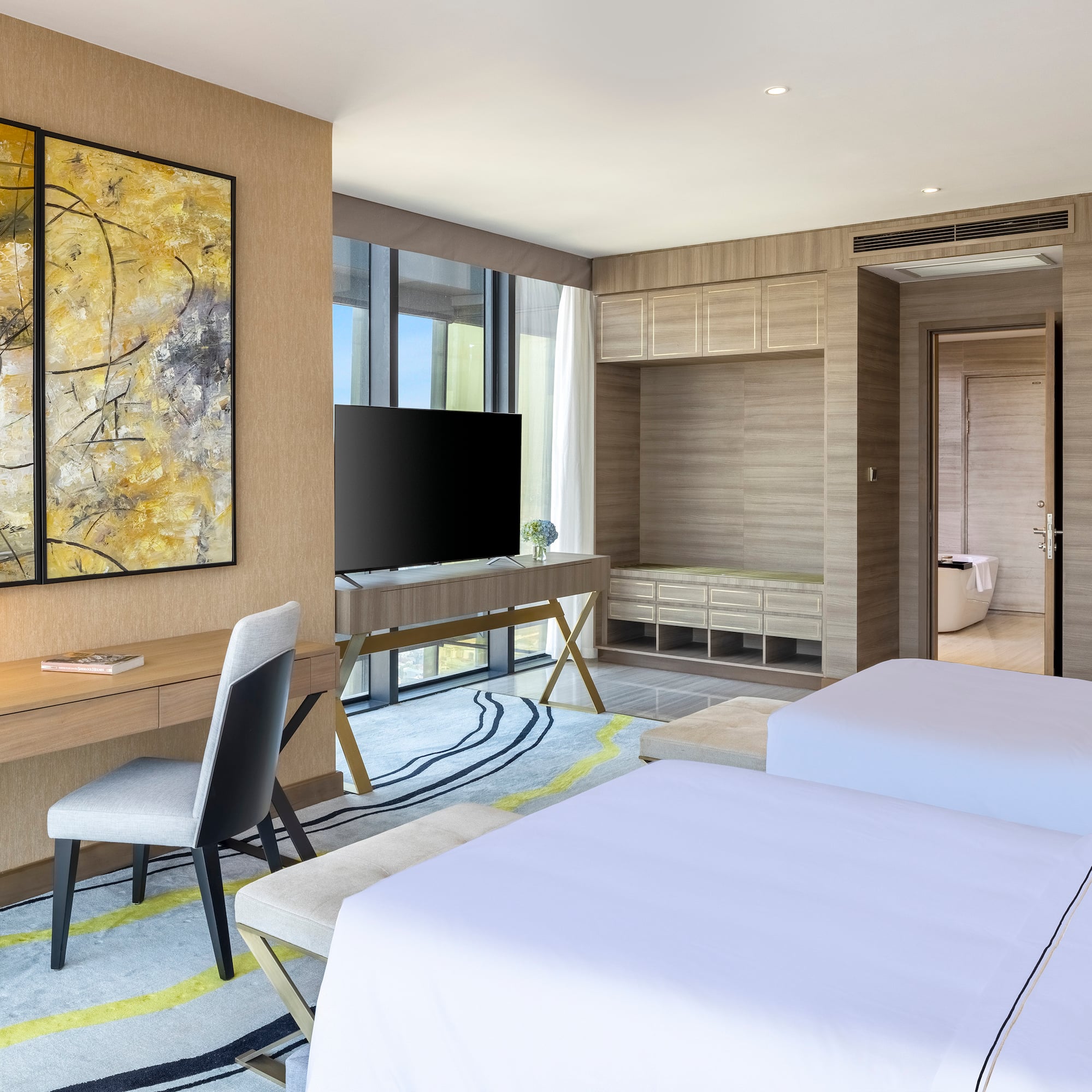 a room with two beds and a tv