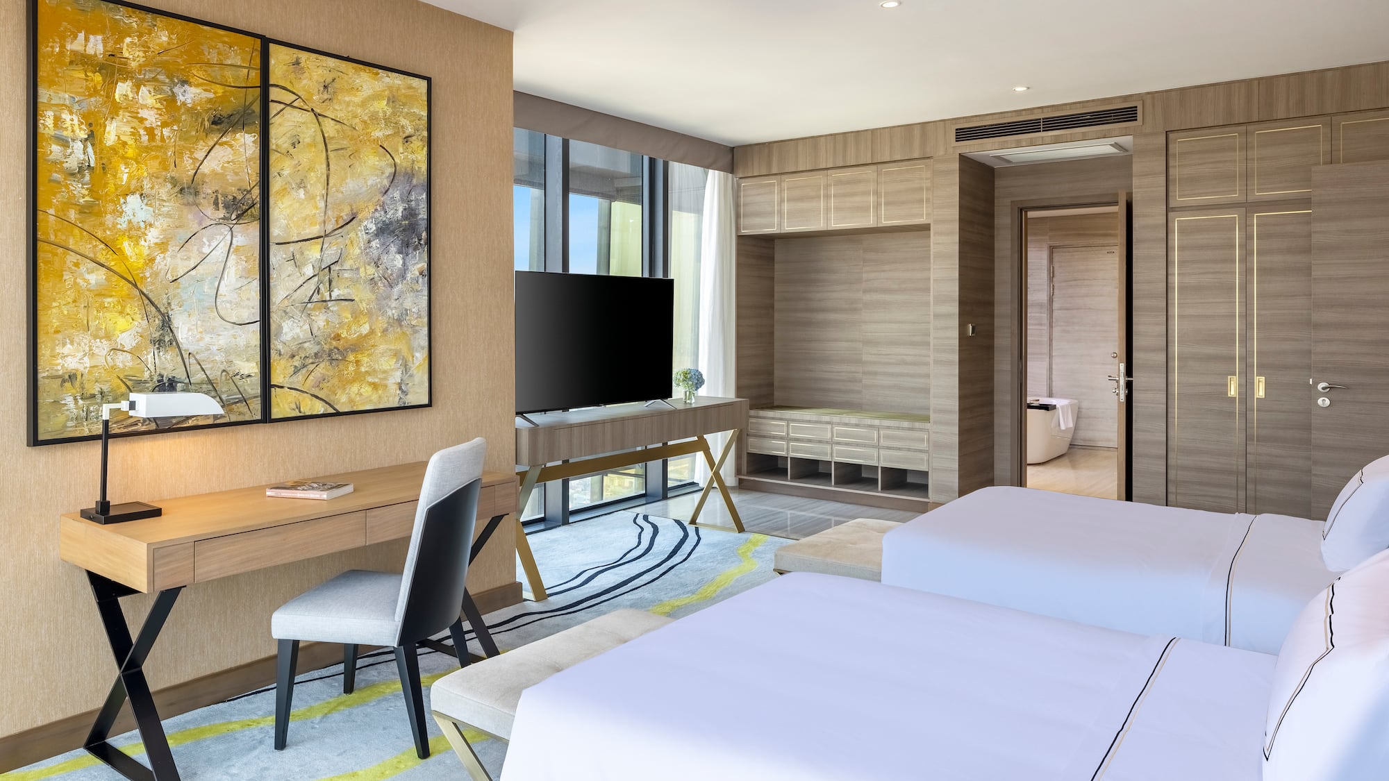 a room with two beds and a tv