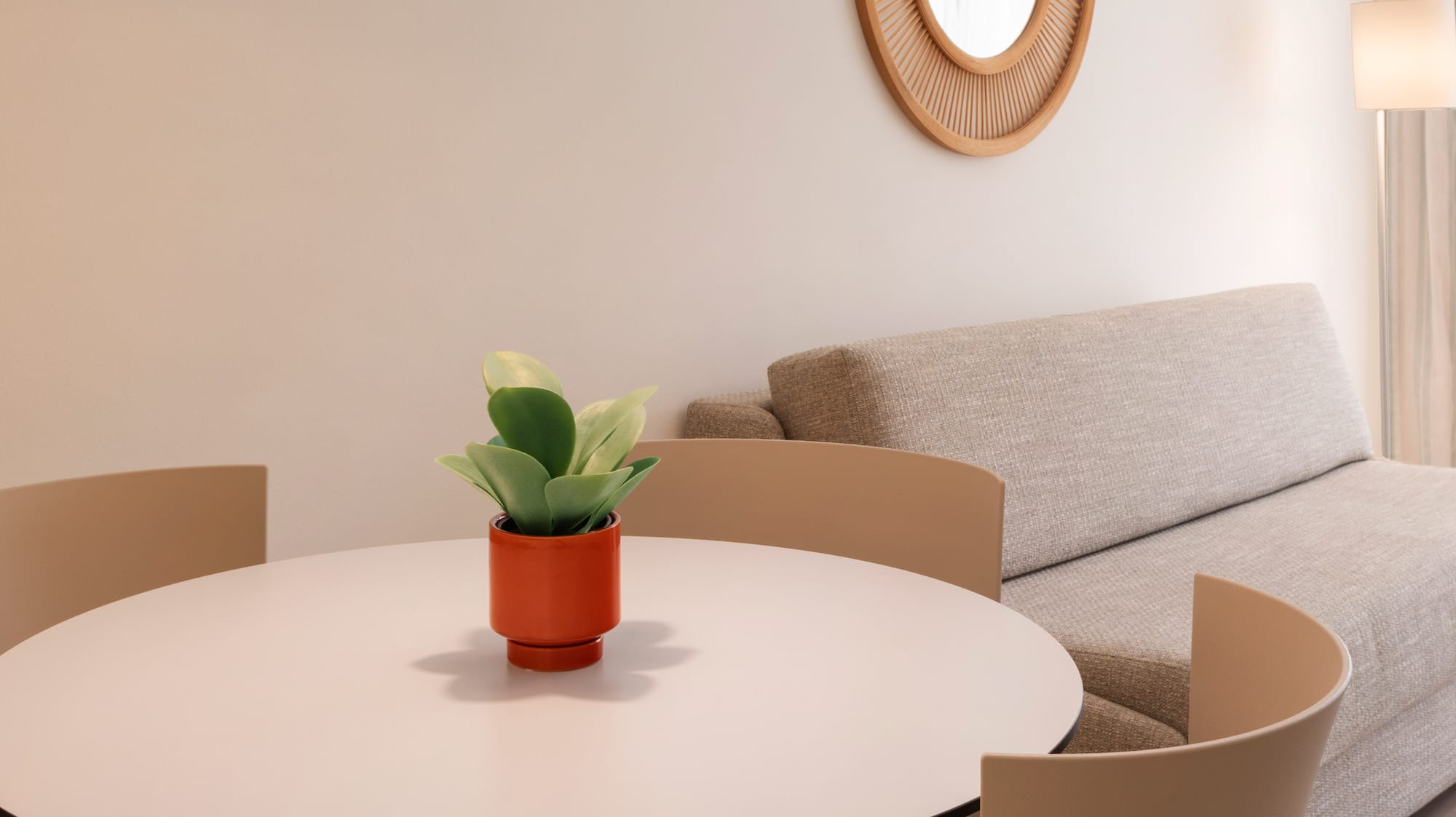 a room with a round table and chairs