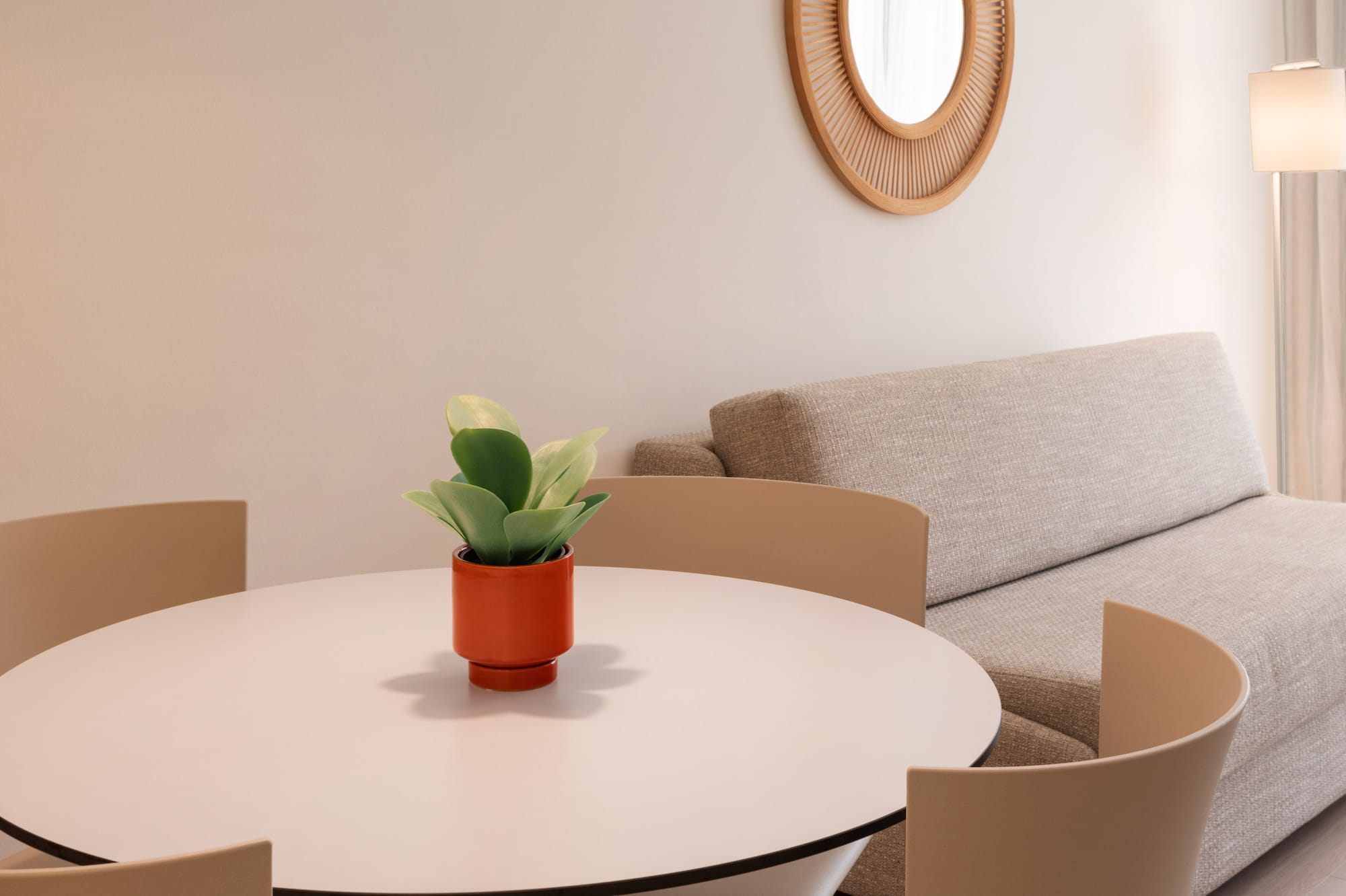 a room with a round table and chairs