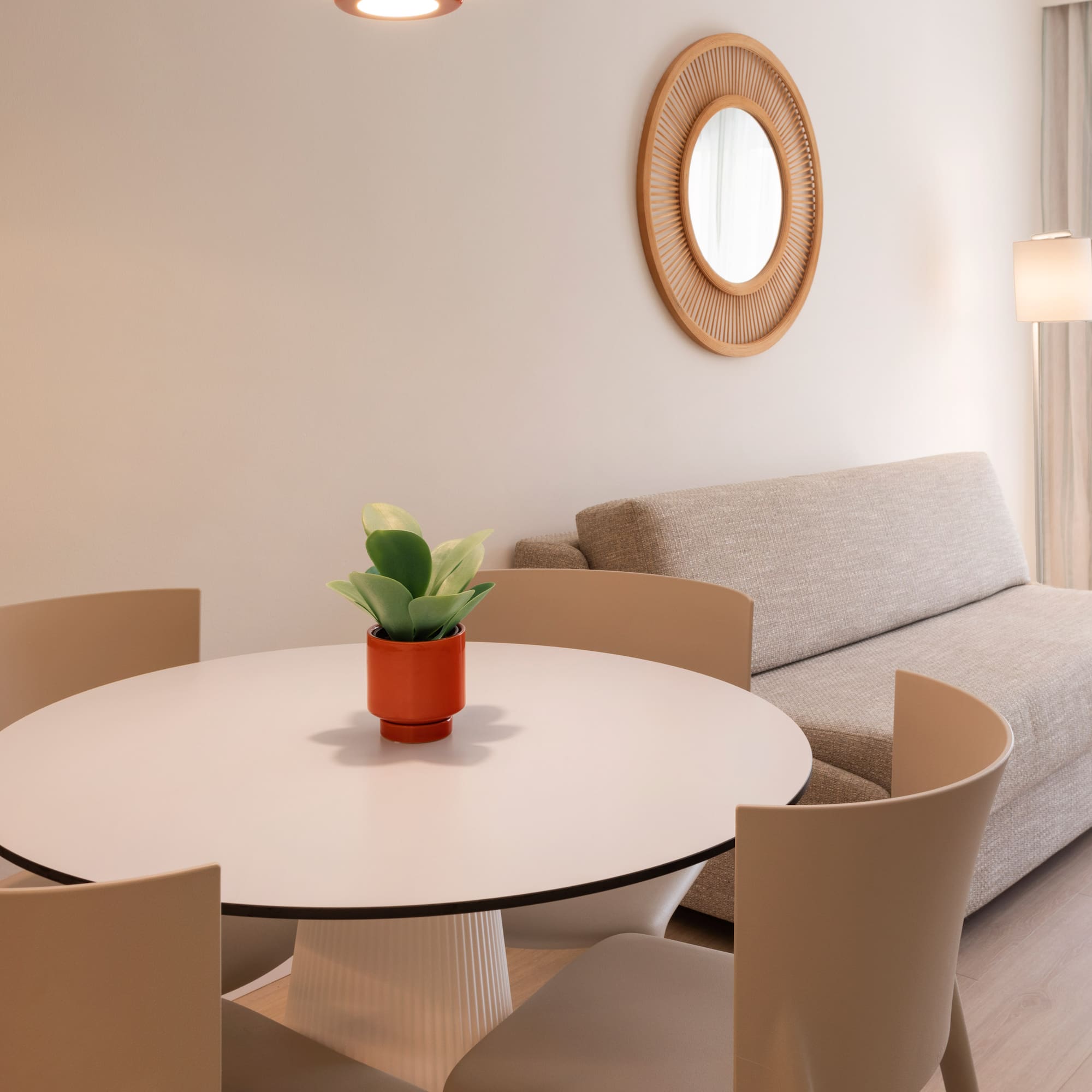 a room with a round table and chairs