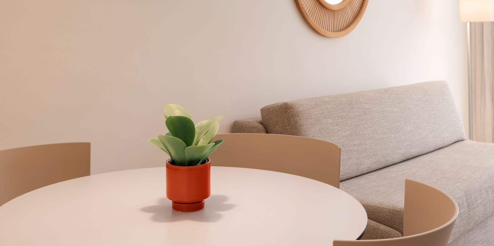 a room with a round table and chairs