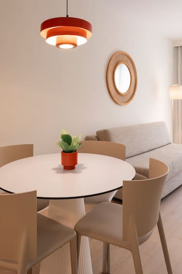 a room with a round table and chairs