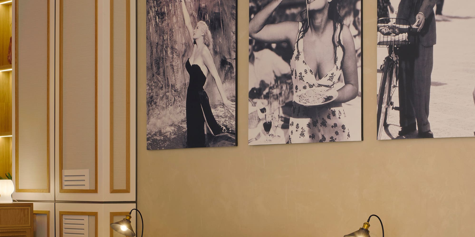 a room with a table and chairs and a table with a couple of pictures on the wall