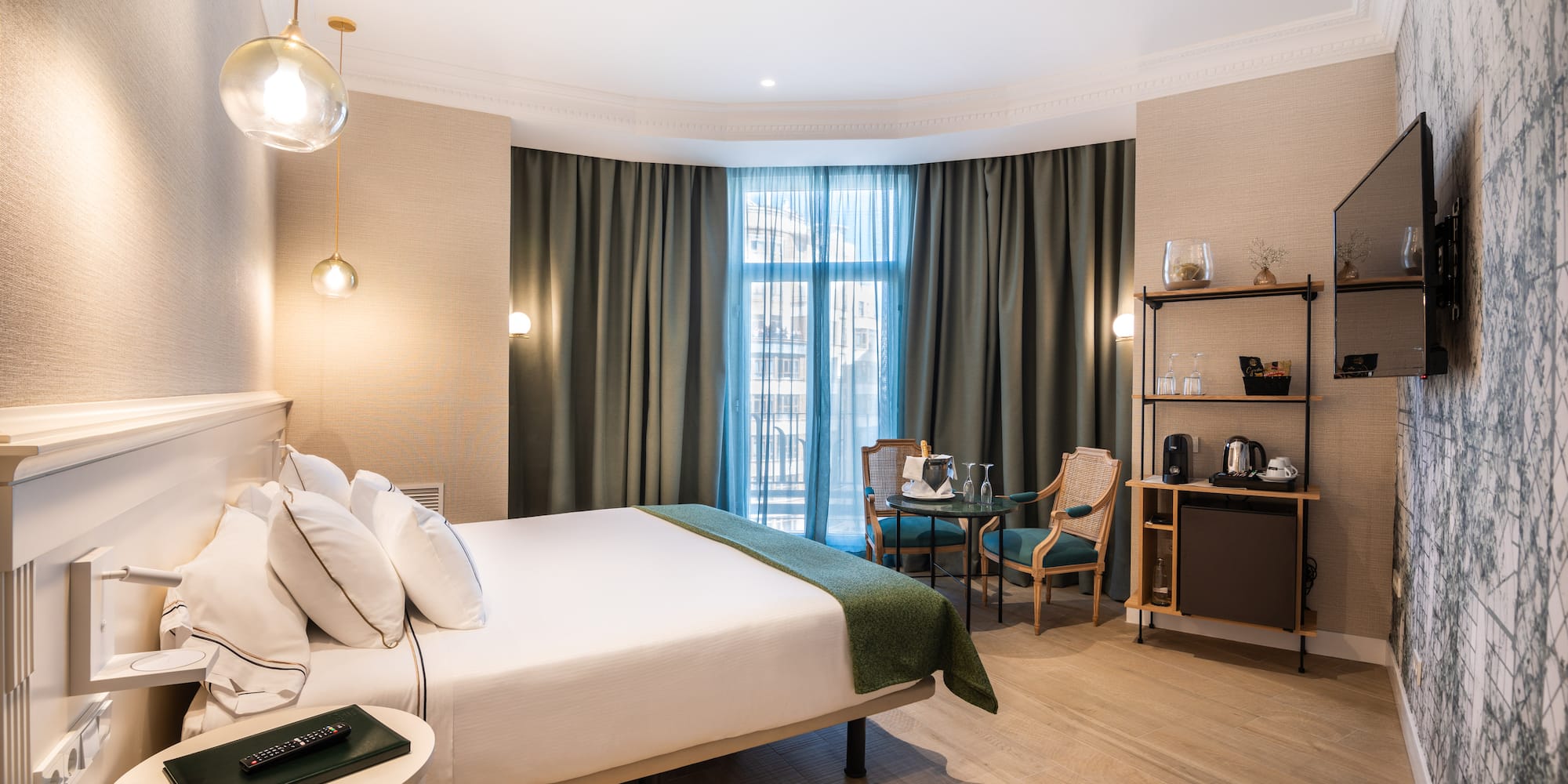 a room with a bed and chairs