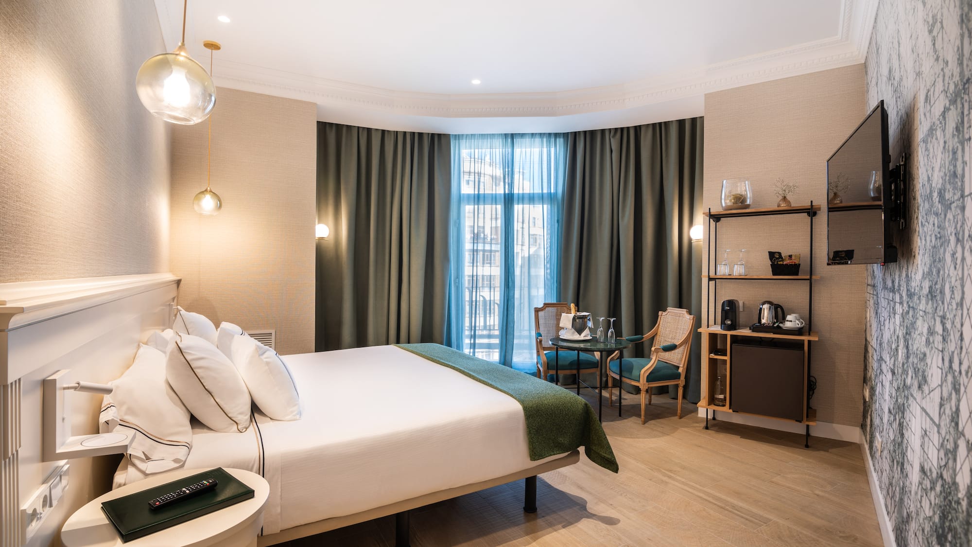 a room with a bed and chairs