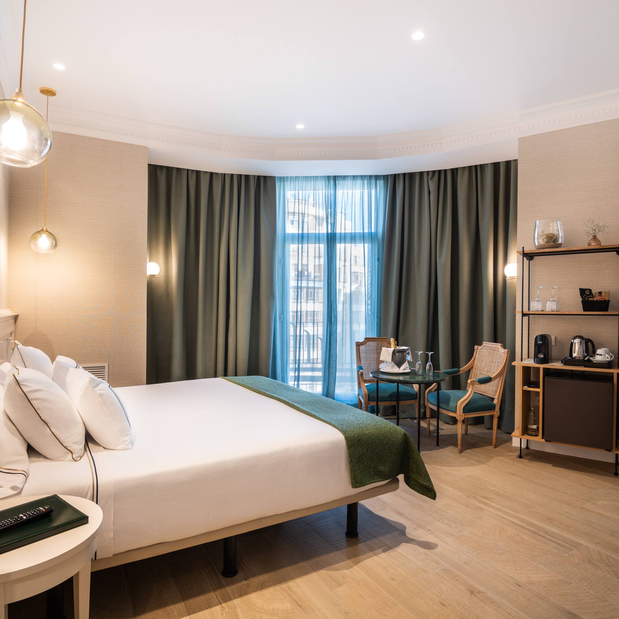 a room with a bed and chairs