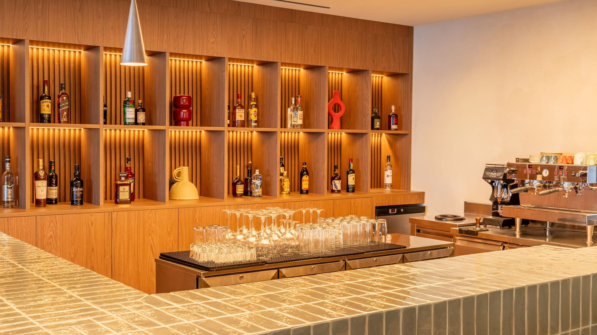 a bar with shelves and bottles of alcohol