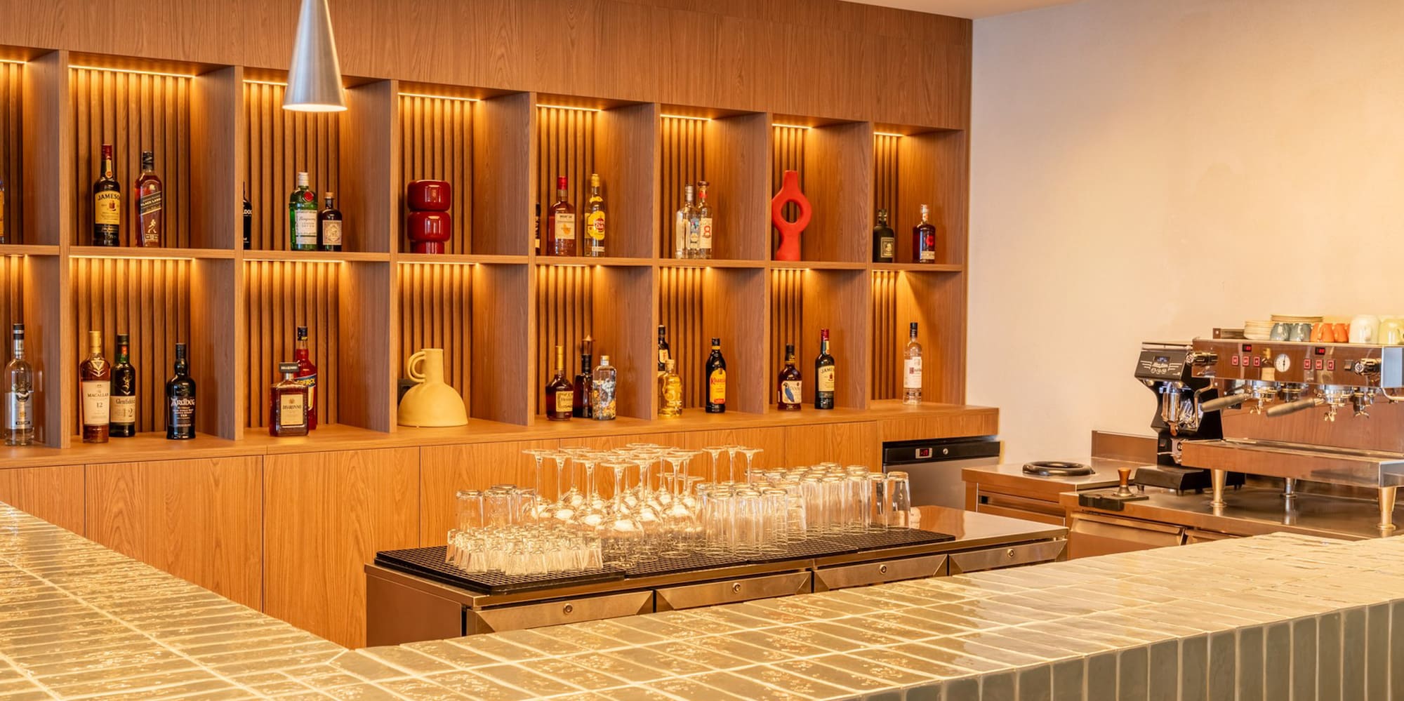 a bar with shelves and bottles of alcohol