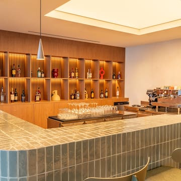 a bar with shelves and bottles of alcohol