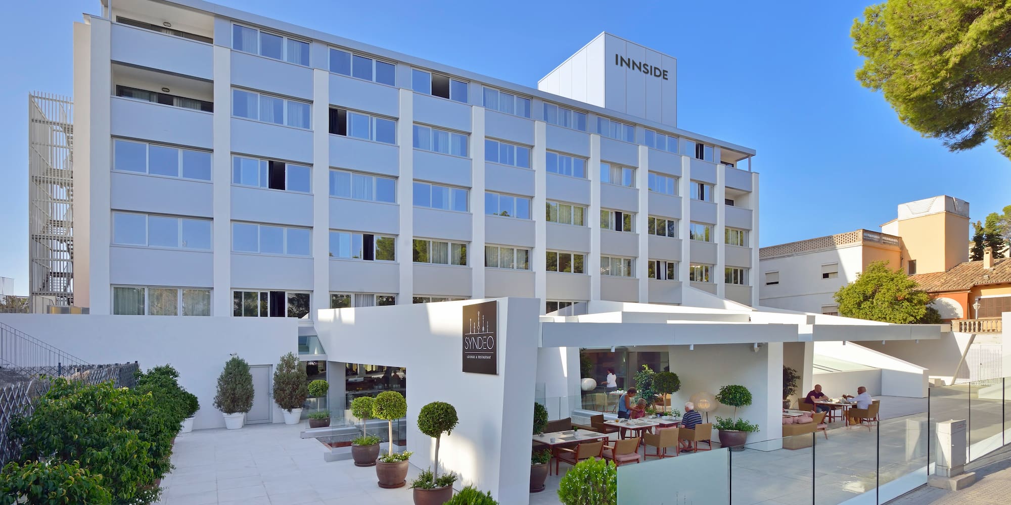 a building with a glass wall and a fence