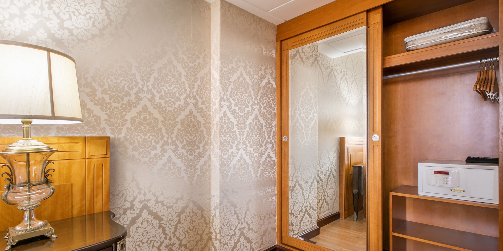 a room with a mirror and a dresser