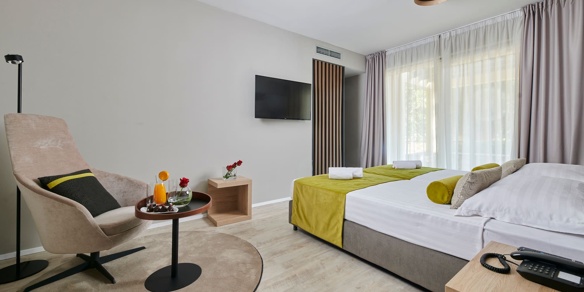 a room with a bed and a television