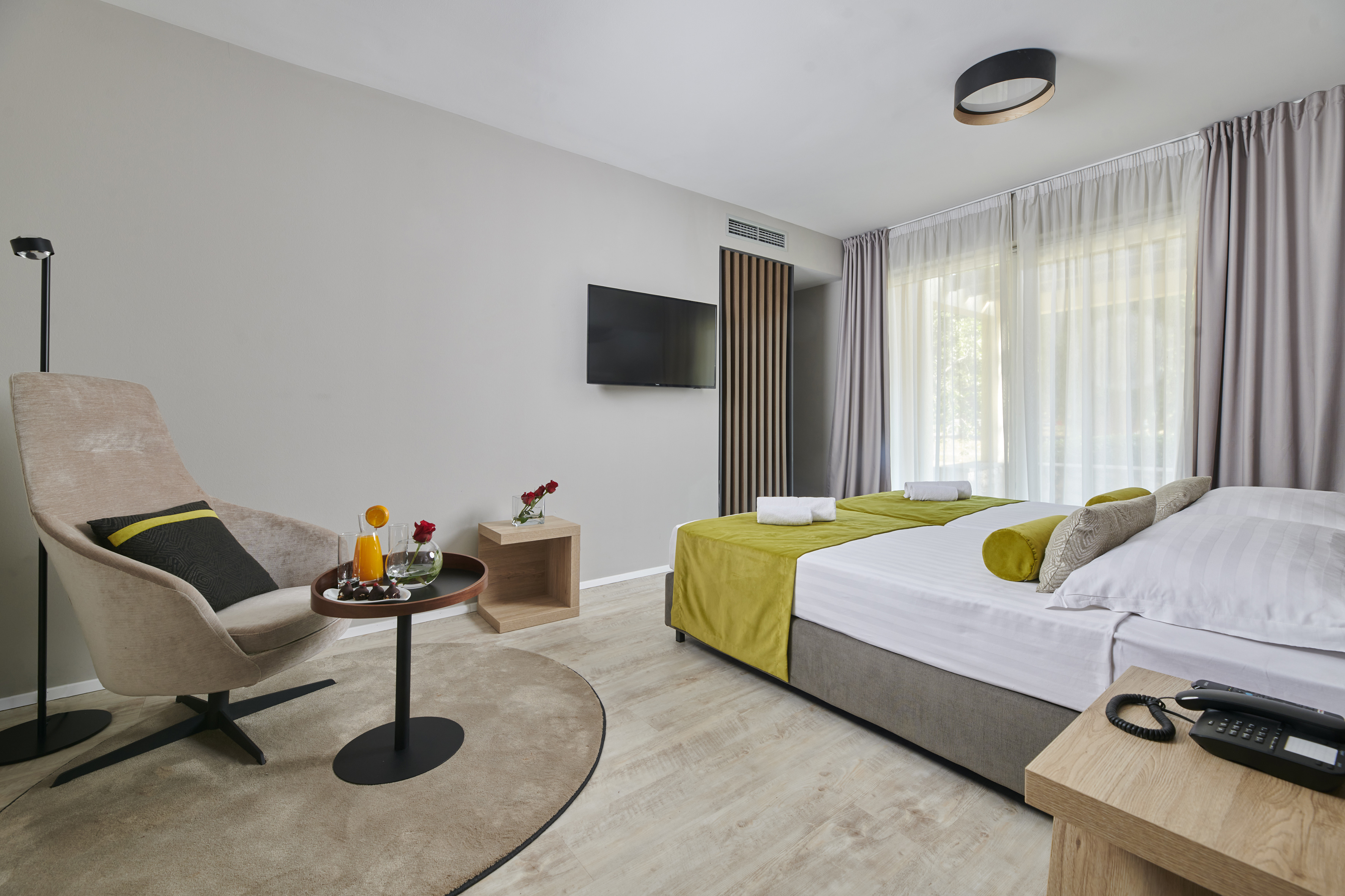 a room with a bed and a television