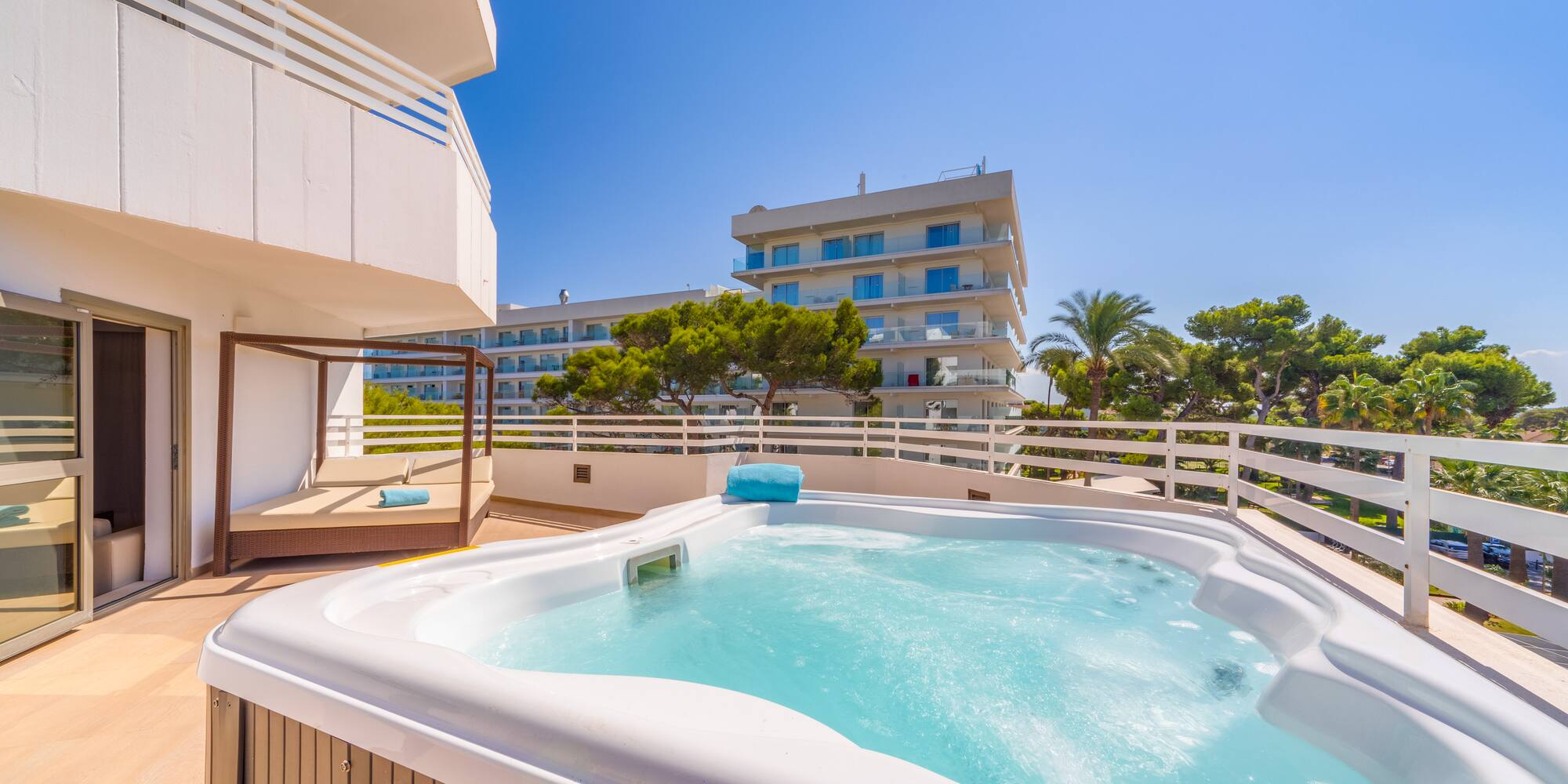 a hot tub on a deck with a balcony and trees