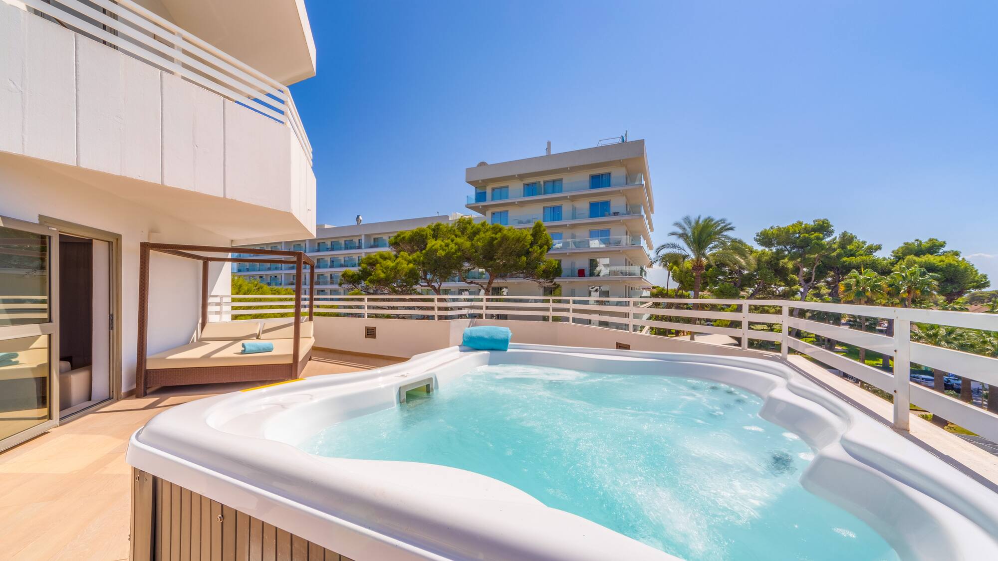a hot tub on a deck with a balcony and trees