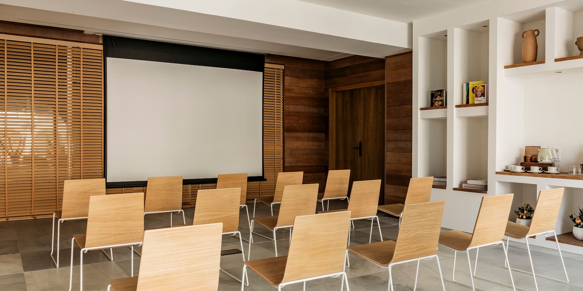 a room with chairs and a projector screen