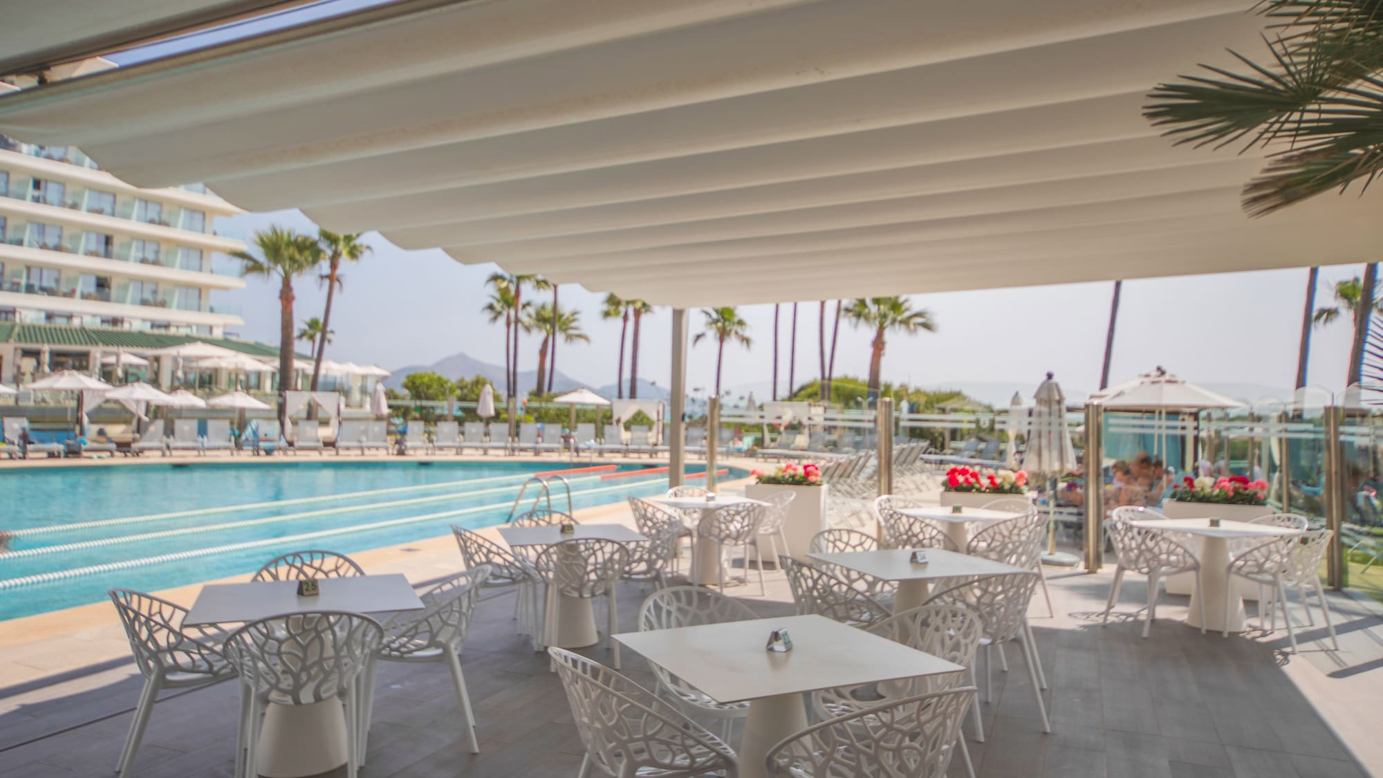 a pool with tables and chairs