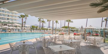 a pool with tables and chairs