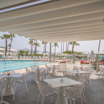 a pool with tables and chairs
