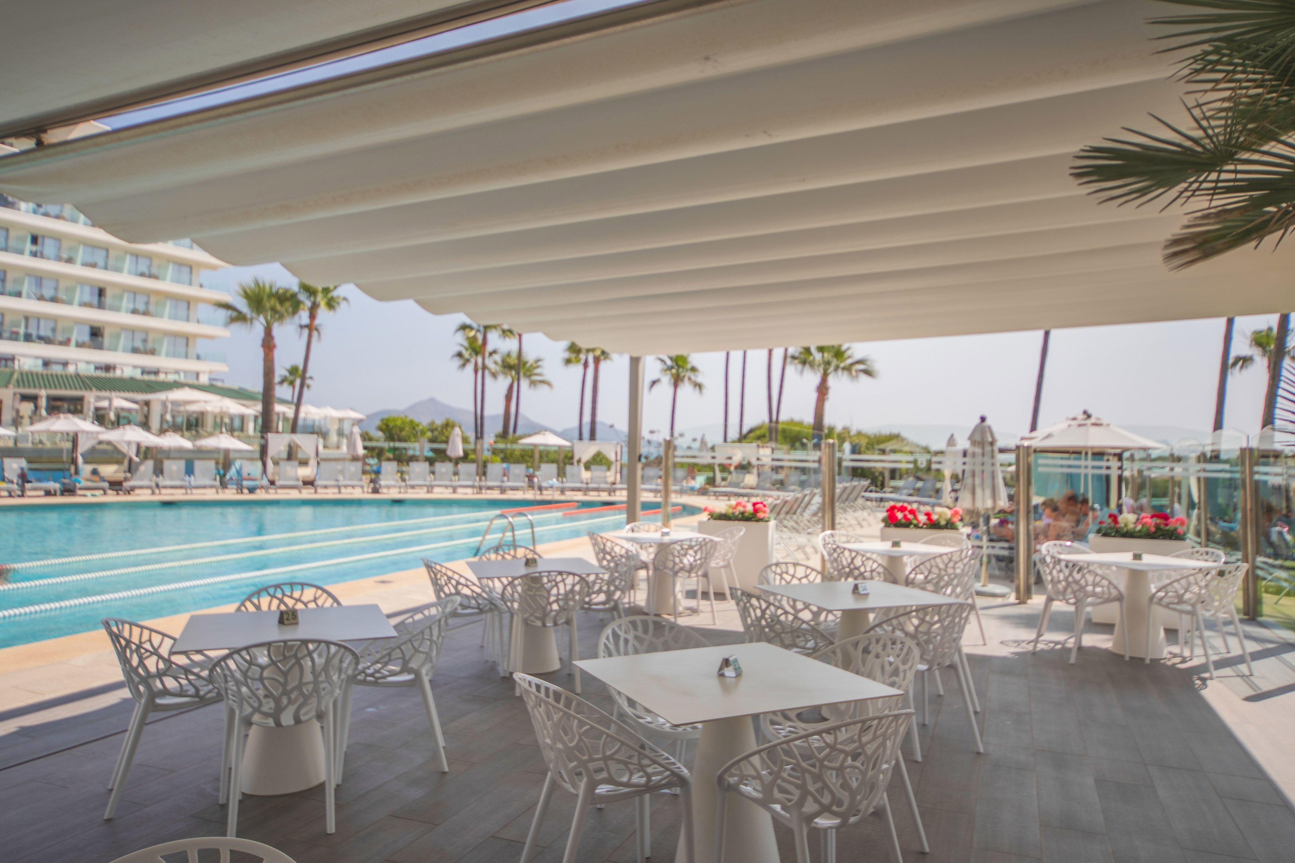 a pool with tables and chairs
