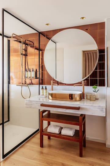 a bathroom with a round mirror