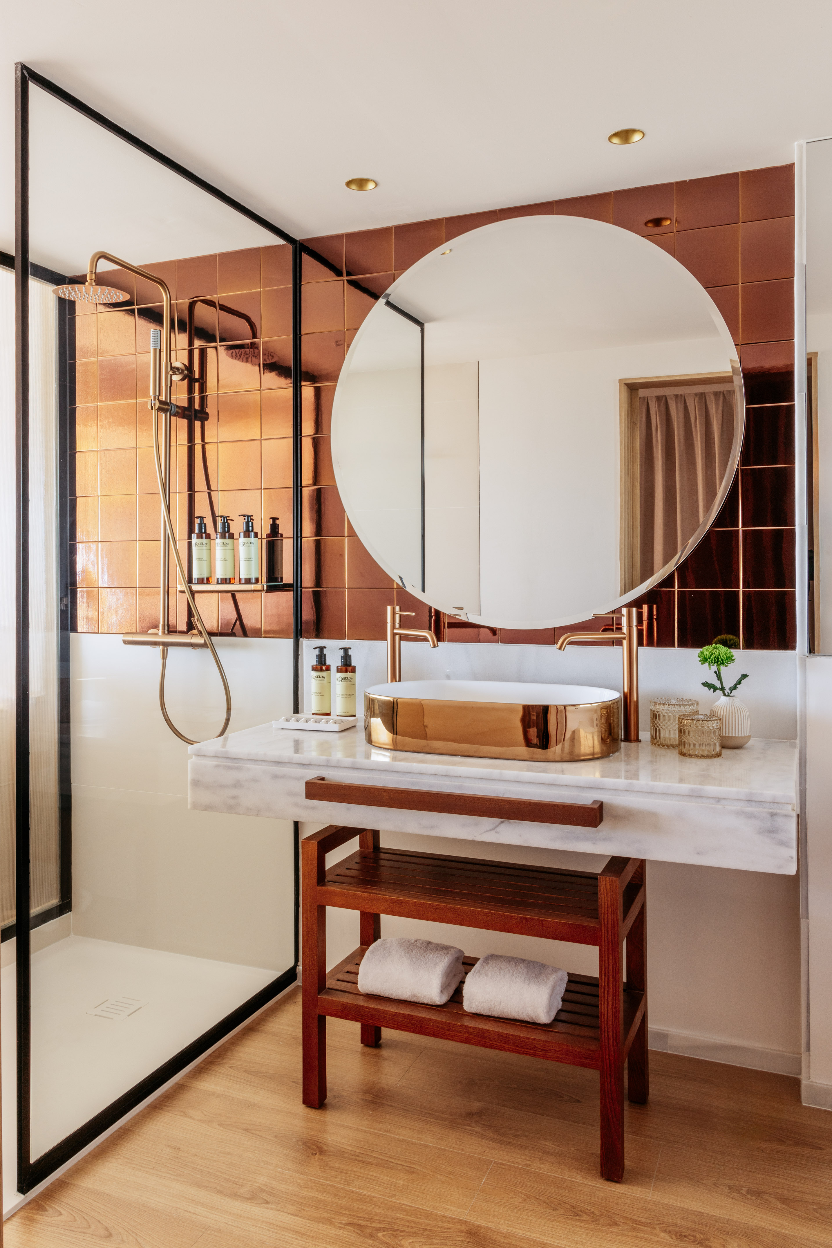 Modern bathroom design: copper tiles, gold fixtures, vessel sink, marble vanity.