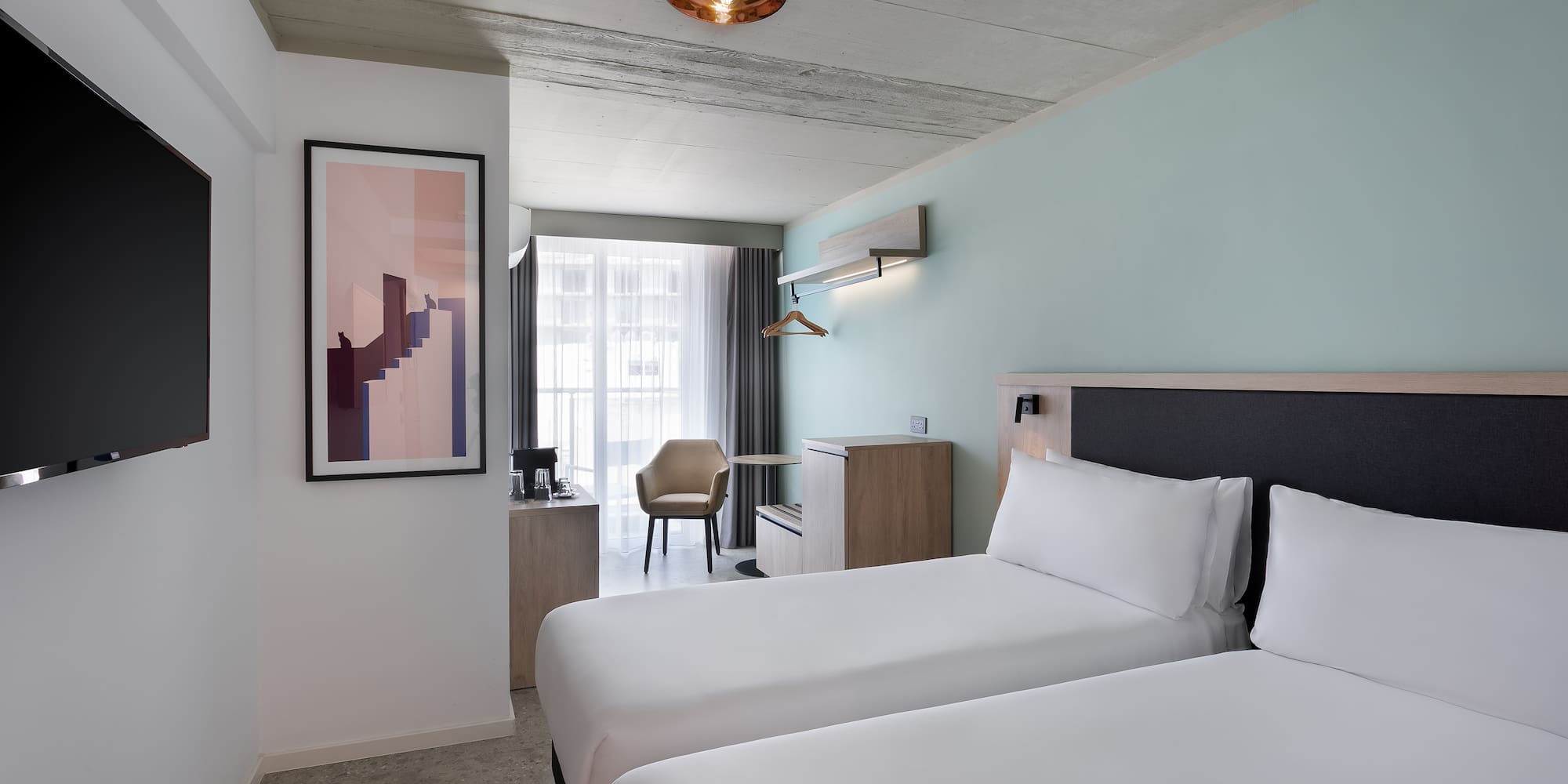 a room with two beds and a lamp