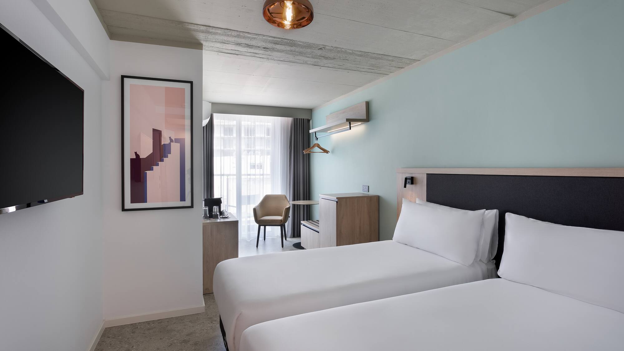 a room with two beds and a lamp