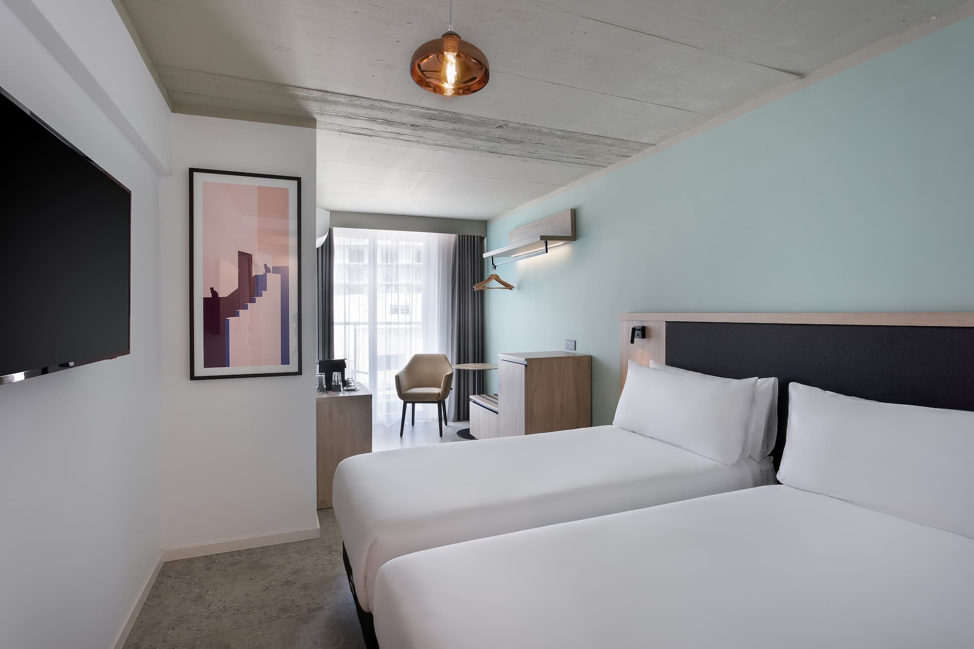 a room with two beds and a lamp