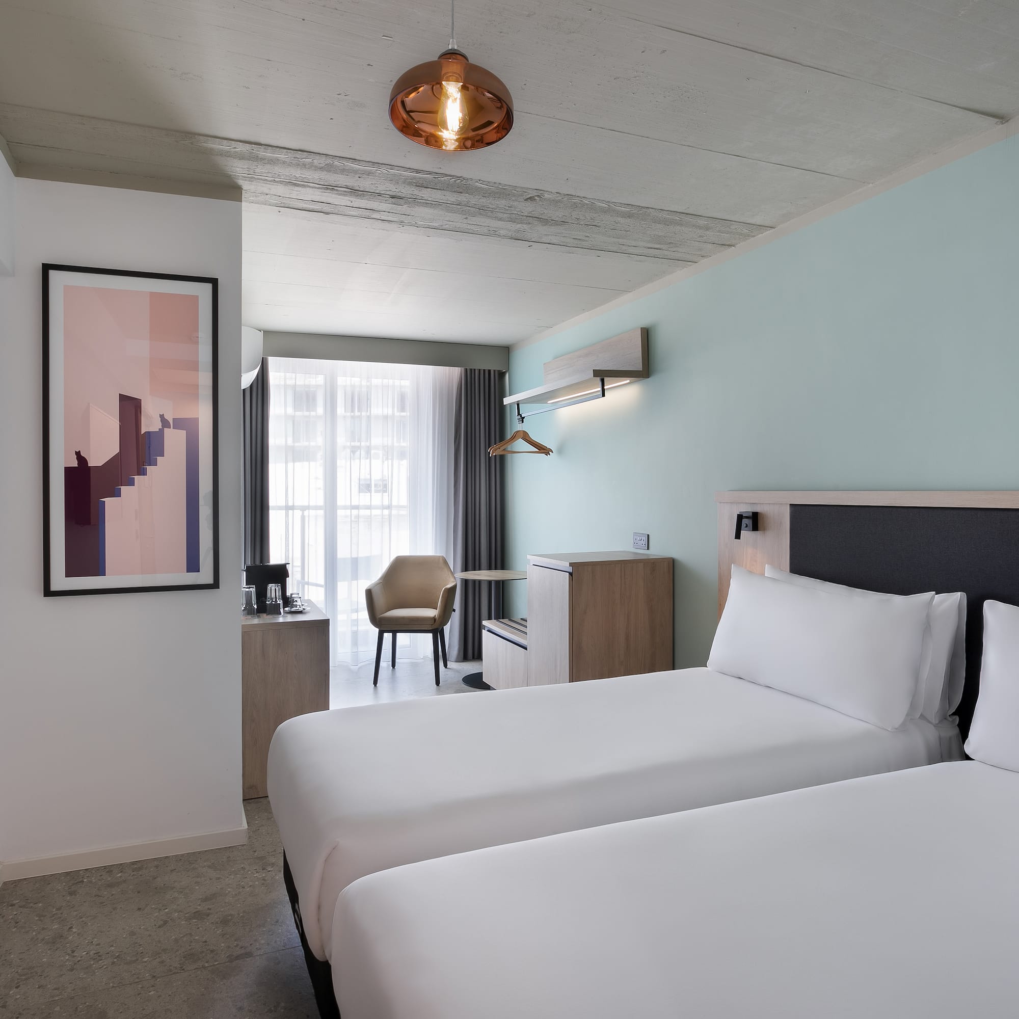 a room with two beds and a lamp