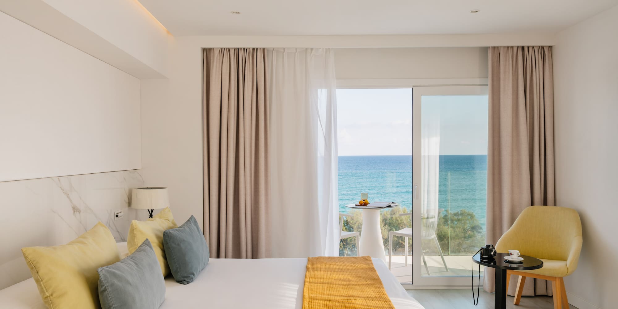 a room with a bed and a table and chairs