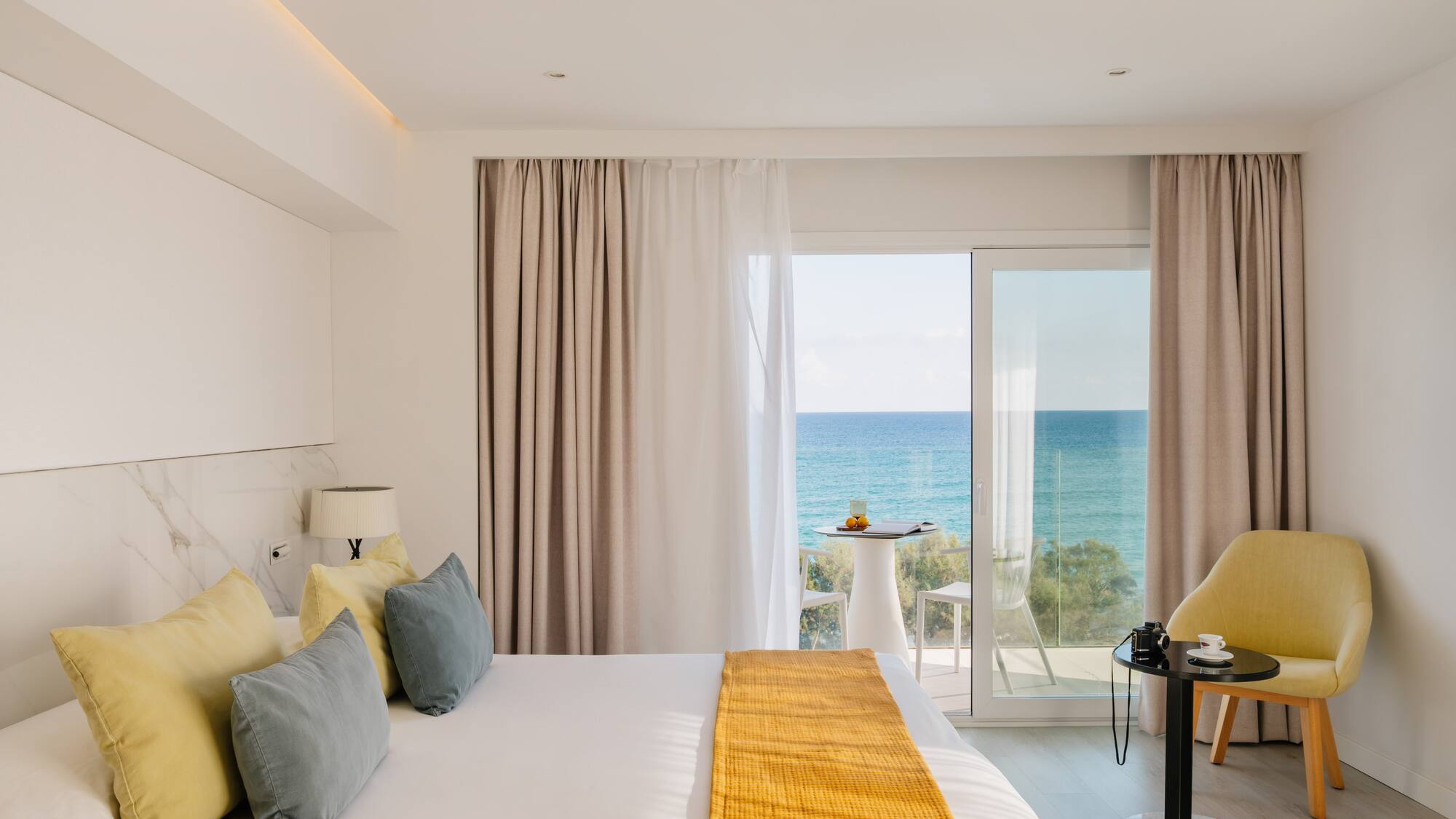 a room with a bed and a table and chairs