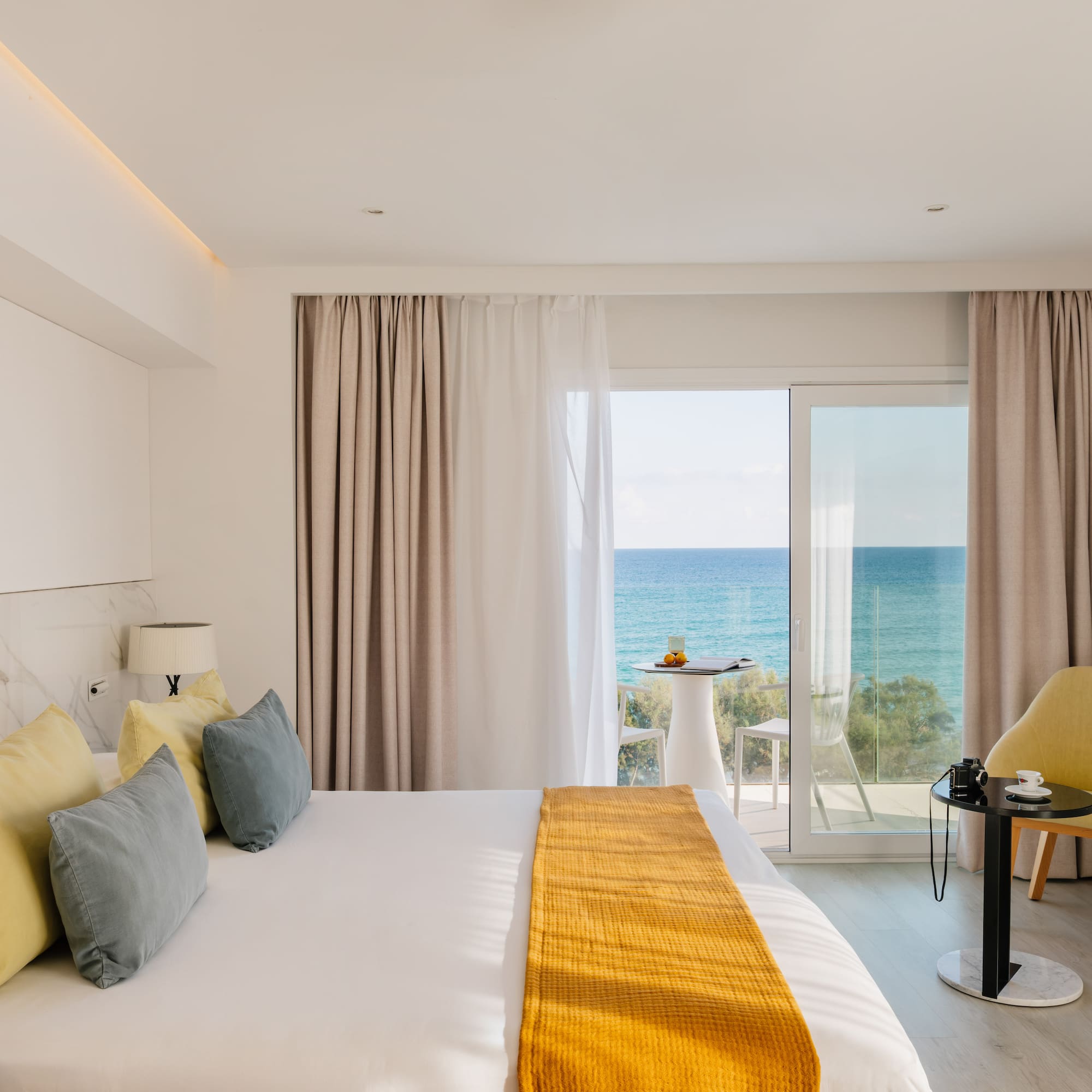 a room with a bed and a table and chairs