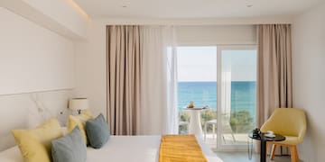 a room with a bed and a table and chairs