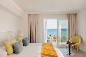 a room with a bed and a table and chairs