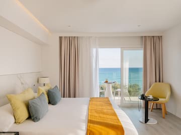 a room with a bed and a table and chairs