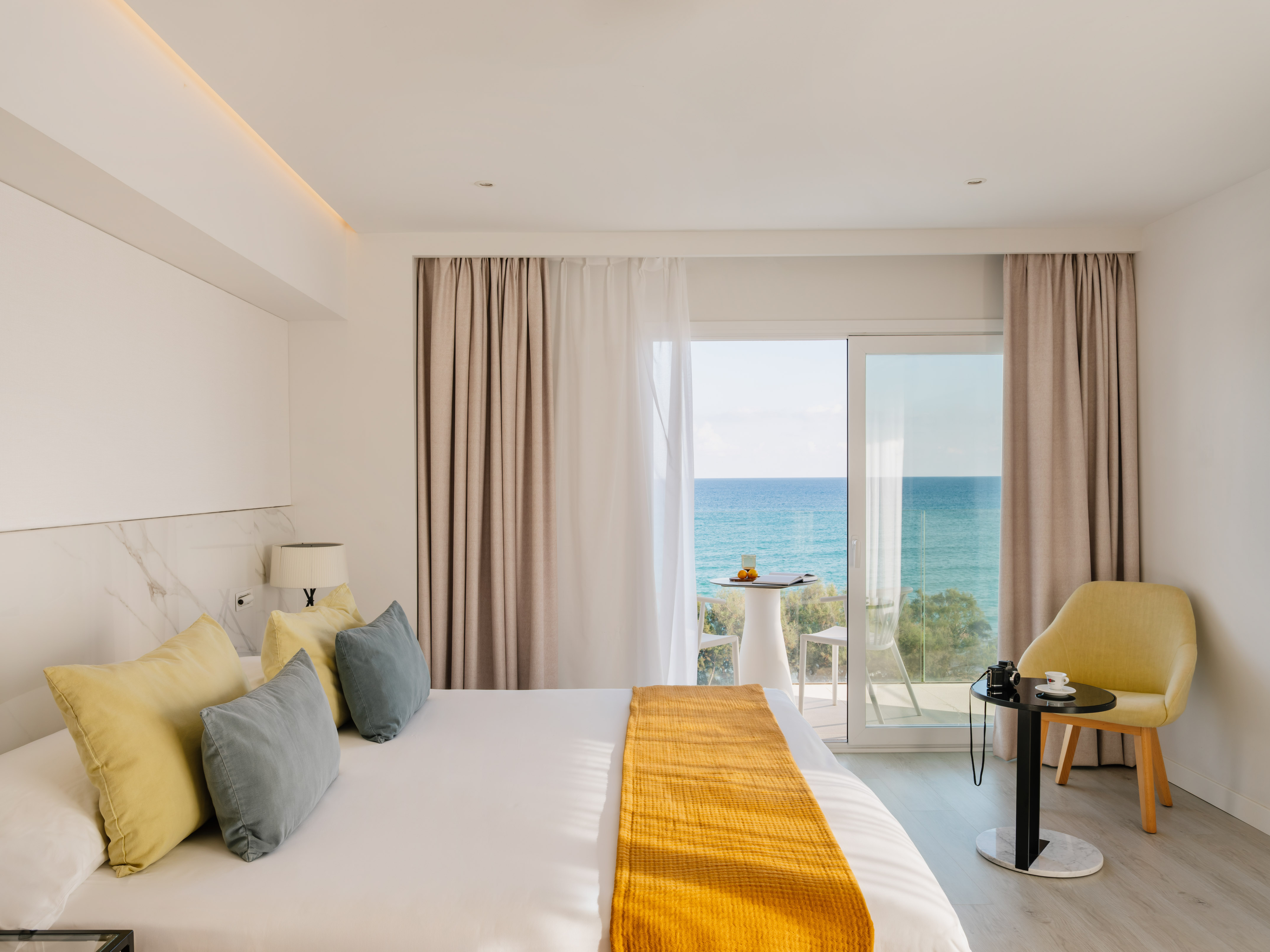 a room with a bed and a table and chairs