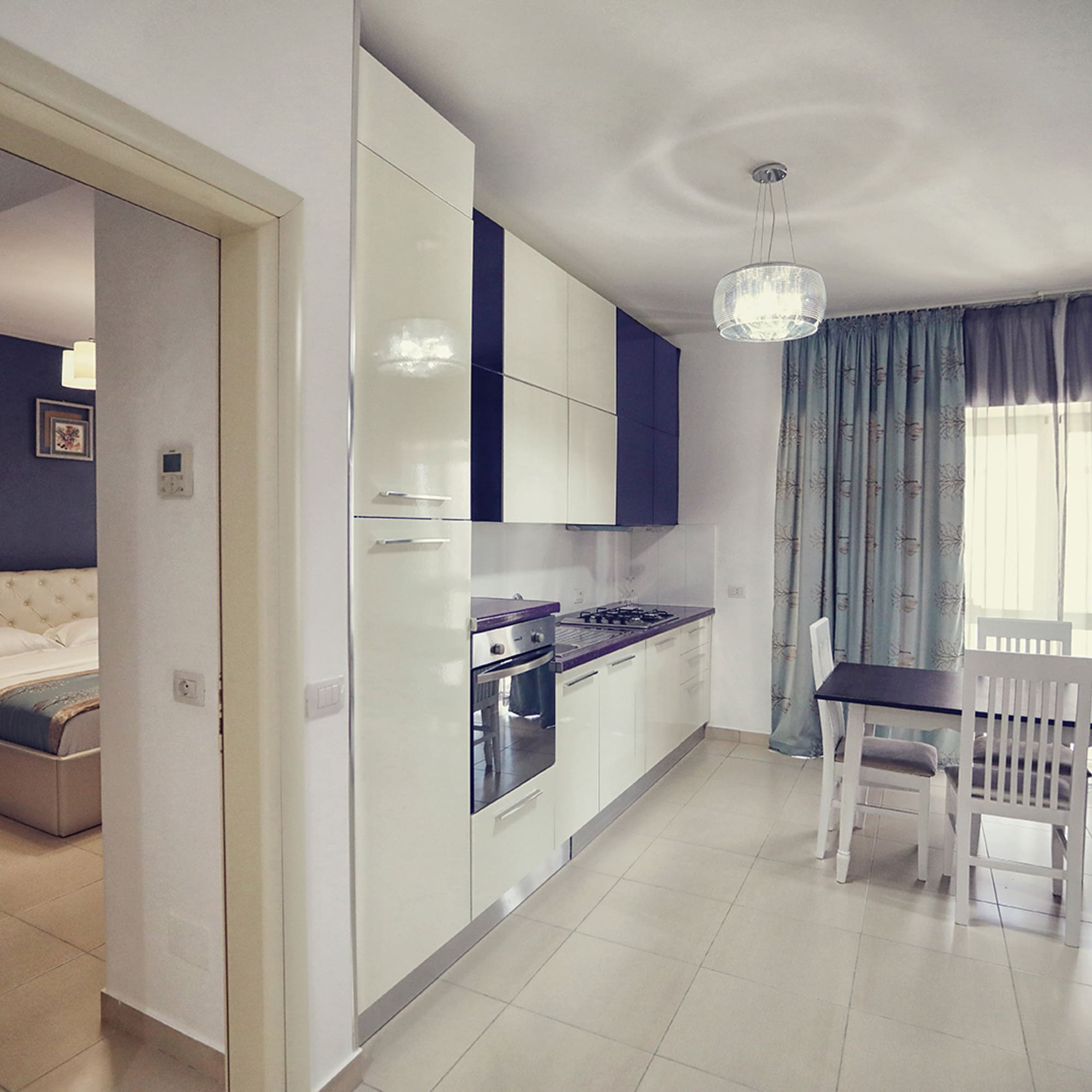 a kitchen with a table and chairs