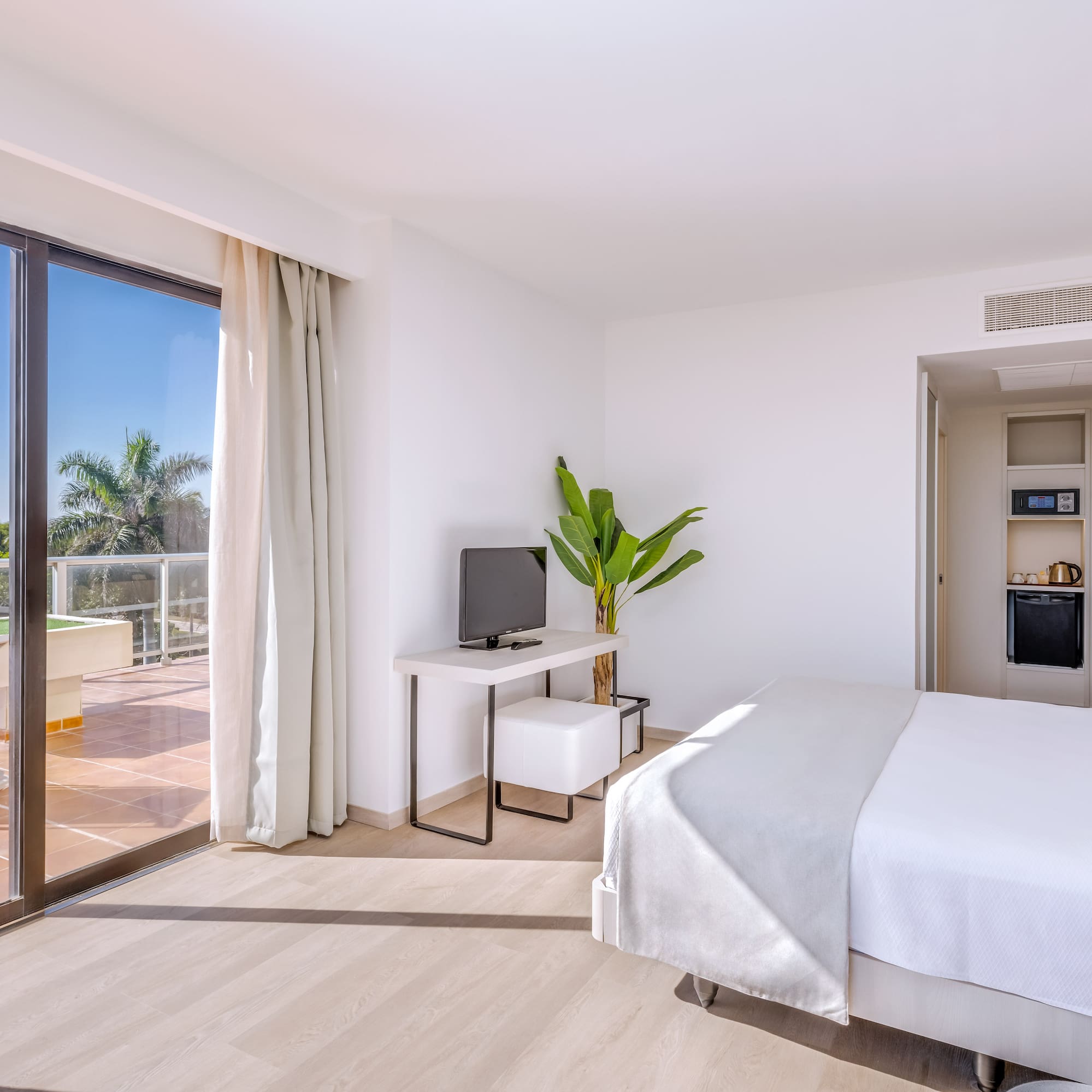 a room with a bed and a television